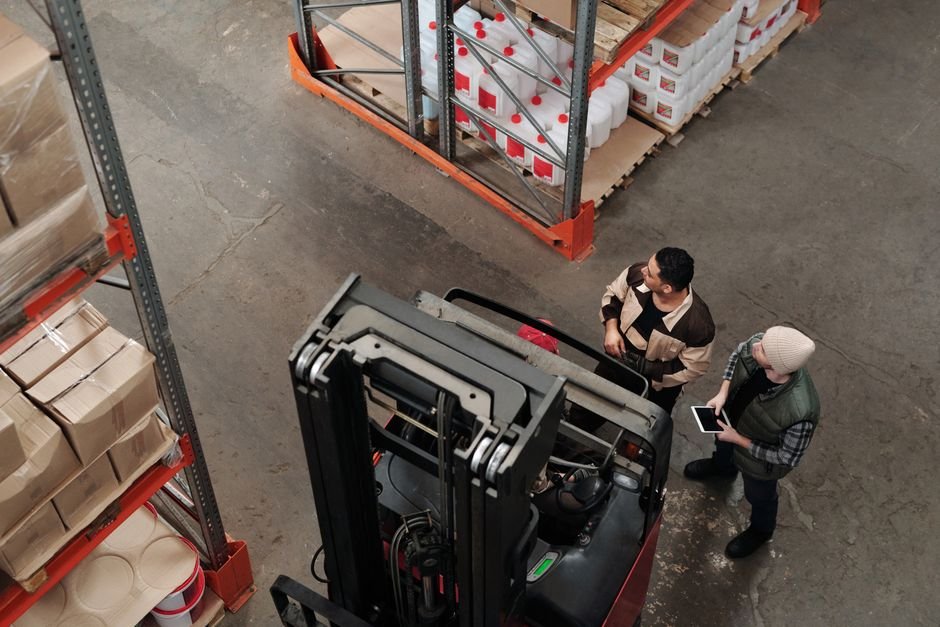 Worker operating equipment in a warehouse
