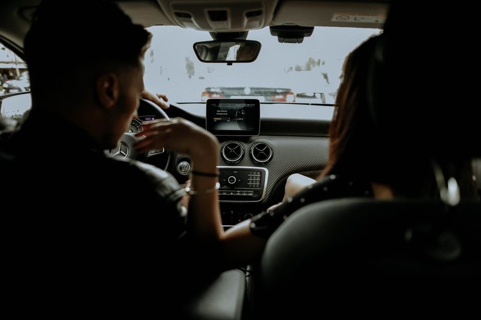 Passenger seated in the back of a car in the city